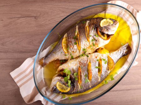 Photo for Lemon baked Dorada fish in a tin - Royalty Free Image