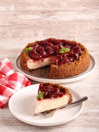 Photo for Homemade cherry topping cheesecake slice on plate - Royalty Free Image