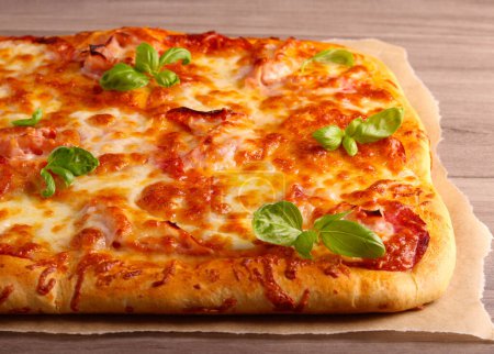 Photo for Fresh homemade rectangle pizza on table - Royalty Free Image