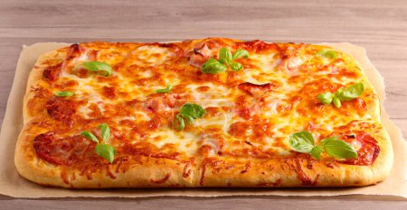 Photo for Fresh homemade rectangle pizza on table - Royalty Free Image