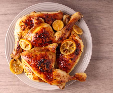 Photo for Lemon, honey and mustard chicken legs on plate - Royalty Free Image