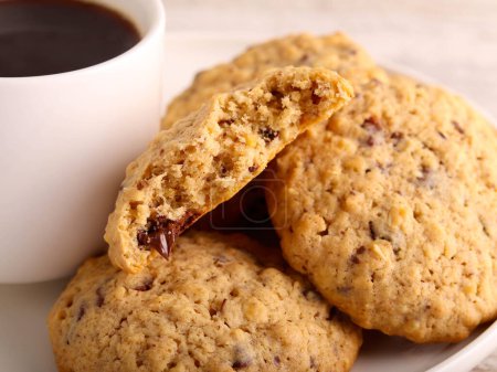 Photo for Oat chocolate chip cookies with cup of coffee - Royalty Free Image