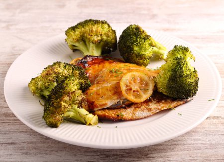 Photo for Lemon dorada fish with broccoli on plate - Royalty Free Image
