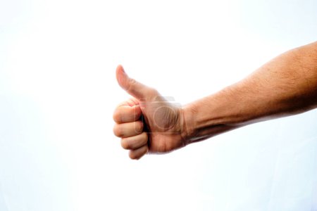 Foto de Man's hand with thumbs up giving an ok, ok sign. - Imagen libre de derechos
