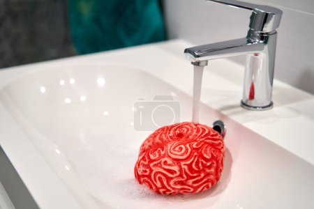 Photo for Human Brain under a Faucet Water Stream, Brainwashing Concept. - Royalty Free Image