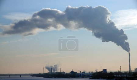 Photo for Kiev, Ukraine January 19, 2021: Chimneys smoke, polluting the air in the city worsening the environment - Royalty Free Image