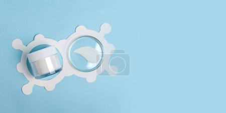 Photo for Top view of petri dish with cosmetic swatch in it and cosmetics box.White molecule structure around.Large banner with negative space. - Royalty Free Image
