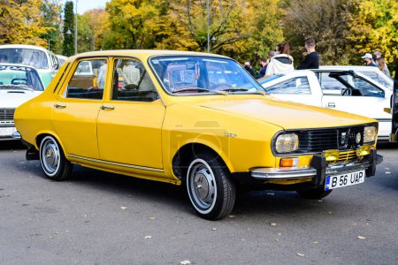 Foto de Bucarest, Rumania, 24 de octubre de 2021: Antiguo coche clásico Dacia 1300 amarillo vivo estacionado en el centro de la ciudad, en un día soleado de otoño - Imagen libre de derechos