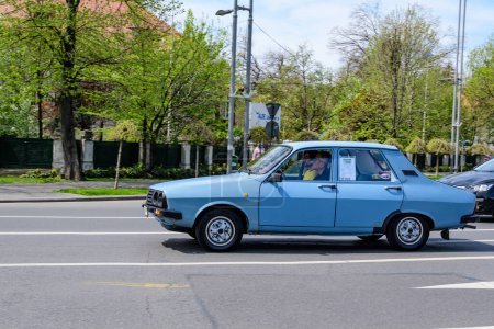 Photo for Bucharest, Romania, 24 April 2021 Old retro vivid blue Romanian Dacia 1310 classic car in traffic in a street in a sunny spring day - Royalty Free Image