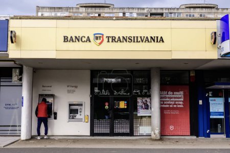Photo for Bucharest, Romania, 14 November 2021: Entry to a Banca Transilvania branch in the city center in a sunny winter day - Royalty Free Image