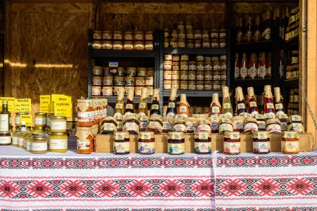 Photo for Bucharest, Romania, 30 November 2023: Traditional organic jam jars and bottles displayed for sale at West Side Christmas Market in Drumul Taberei neighborhood, in a sunny cold day - Royalty Free Image