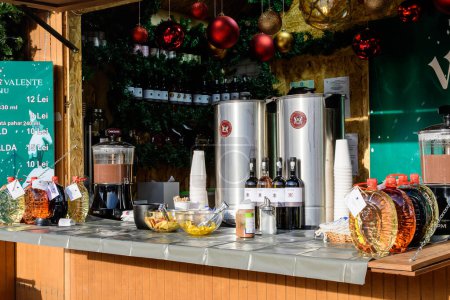Photo for Bucharest, Romania, 30 November 2023: Mulled wine displayed for sale at West Side Christmas Market in Drumul Taberei neighbourhood, in a sunny cold day - Royalty Free Image