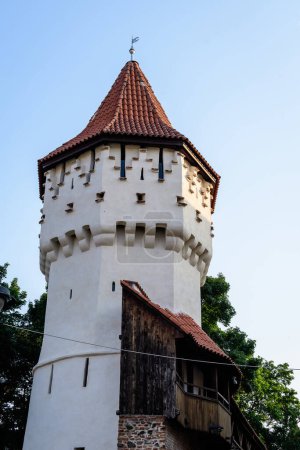 Large old white painted stone tower in the historical center of the Sibiu city, near Citadel Street and Park (Strada si Parcul Cetatii), in Transylvania (Transilvania) region of Romania, in summer