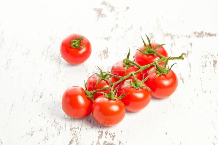 Cherry tomatoes on a white wooden textured background. Close-up of cherry tomatoes