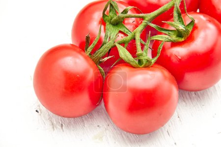 Ripe cherry tomatoes on a white structural background