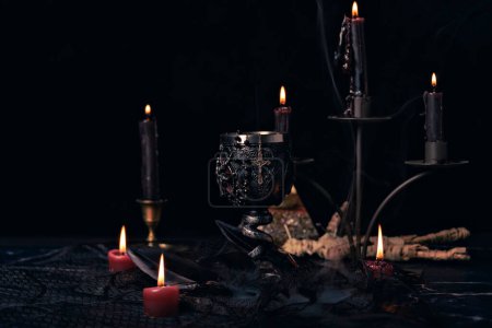 Téléchargez les photos : Composition sorcellerie avec bougies allumées, livres, bijoux et symbole pentagramme, concept occulte, rituel de magie noire - en image libre de droit