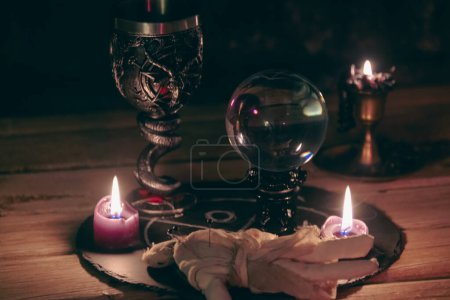 Mysterious Occult Ritual Setup with Crystal Ball and Candles