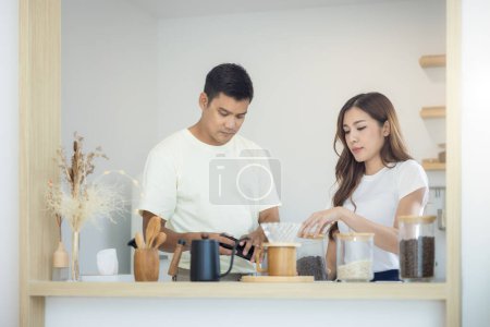 Photo for Couple or 2 asian people to make, brew coffee together in kitchen home. Include cup, mug and kitchenware on table. Concept for morning lifestyle, love, happy, family and relationship. - Royalty Free Image