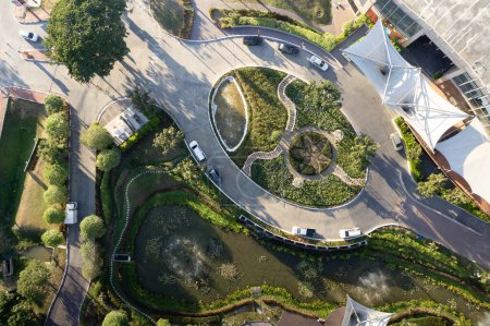 Foto de Garden, park in aerial view or top view. Green zone in city with beautiful landscape consist of plant, tree, water in lake or pond, roundabout or road for travel, parking, U-turn and decoration place. - Imagen libre de derechos