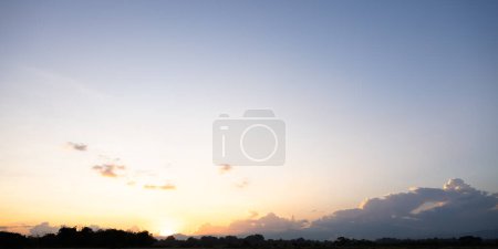 Photo for Beautiful sky and cloud at high. Landscape include space, light of nature, sunset, sunrise, horizon or skyline. Colorful with yellow, orange and blue at evening in autumn for background and wallpaper. - Royalty Free Image