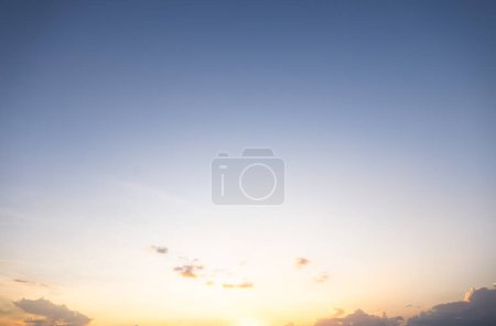 Photo for Beautiful sky and cloud at high. Include space, light of nature, sunset, sunrise. Colorful with yellow, orange and blue color at evening time in autumn for scene, backdrop, background and wallpaper. - Royalty Free Image