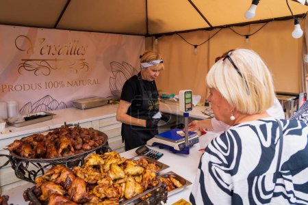 Photo for A vendor serves a customer at a street food festival. June 25, 2022 Balti Moldova. Illustrative editorial - Royalty Free Image