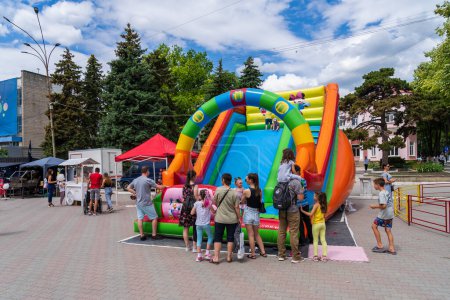 Photo for Inflatable slide. Area for entertainment of children at a street festival. June 25, 2022 Balti Moldova. Illustrative editorial - Royalty Free Image