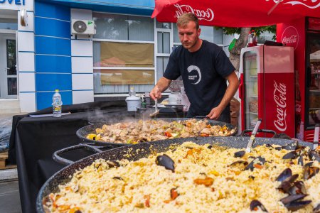 Photo for Chefs prepare food at the street food festival. June 25, 2022 Balti Moldova. Illustrative editorial - Royalty Free Image