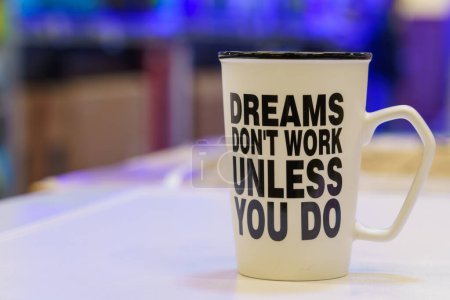Photo for Work mug with motivational inscription dreams dont work unless you do. Illustrative editorial. February 2, 2022 Balti Moldova - Royalty Free Image