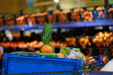 Photo for A box with products in a grocery cart for collecting an online order and delivering it to a customer. Illustrative editorial. April 19, 2022 Balti Moldova - Royalty Free Image