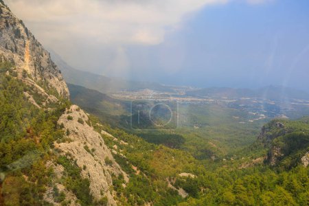Photo for View from inside the cabin on the cable car when climbing Mount Tahtali in the Western Taurus mountain system. Illustrative editorial. August 9, 2022 mountain near Kemer, Antalya province, Turkey - Royalty Free Image
