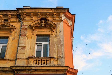 Photo for Corner of the house of classical European architecture of the old cozy tourist city. Background with selective focus and copy space - Royalty Free Image