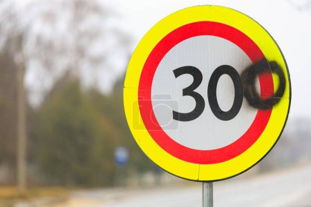 Photo for The vandals painted the number zero on a road sign with a speed limit of 30 kilometers per hour. 300 kilometers per hour sign background - Royalty Free Image