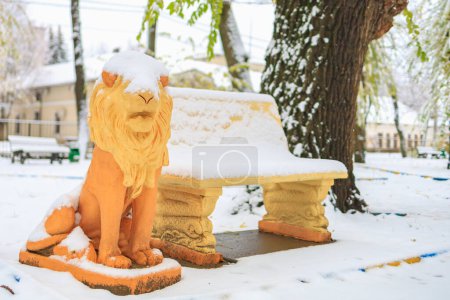 Foto de Nieve en la escultura del león en el parque. Fondo de invierno con enfoque selectivo - Imagen libre de derechos