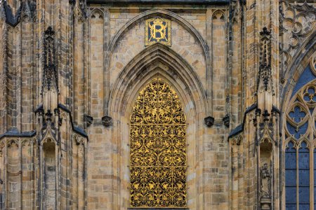 Photo for Golden window. Details of the exterior of the Gothic Catholic Cathedral of St. Vitus, Wenceslas and Vojtech in Prague Castle. Background with selective focus and copy space - Royalty Free Image