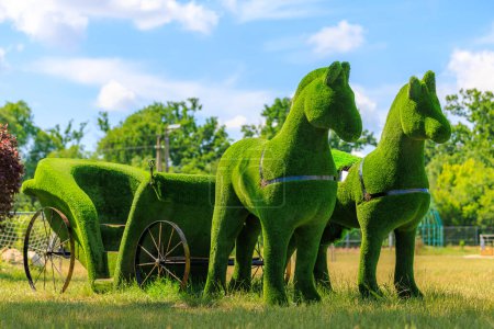 Horses harnessed to a carriage flower bed. Background with selective focus and copy space for text.