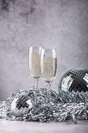 Photo for Glass of champagne with silver mirror disco ball. New year party composition - Royalty Free Image