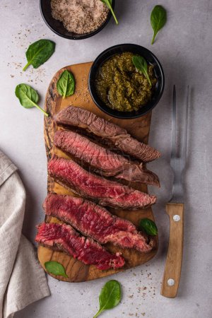 Foto de Different degrees of steak roasting. Steak with blood, medium to high roast steak on a wooden board - Imagen libre de derechos