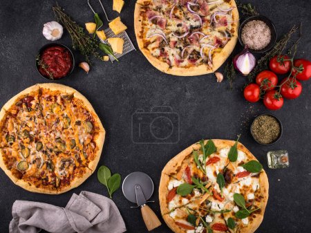 Assortment of various types of Italian pizza with bacon, chicken meat, soft cheese and tomato