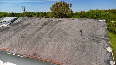 Photo for Roof missing shingles due to age, weather and storm damage - Royalty Free Image