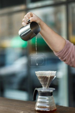 Photo for Brewing coffee in a funnel. Pour over Coffee In Funnel. Alternative Method. Beautiful table with dark background. The process of brewing the coffee specialty. - Royalty Free Image