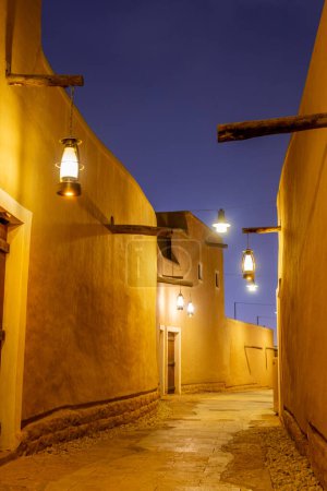 Photo for Diriyah old town traditional street illuminated at night, Riyadh, Saudi Arabia - Royalty Free Image