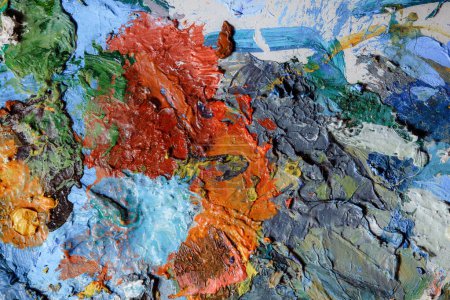 Colorful abstract texture. Smears of oil paint on an art palette. The concept of the modern school of art. Fragment of creative work. Colors of the year 2023 