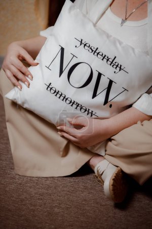 Photo for Pillow with the inscription: now. You need to live your life today. Motivational inscription to act now. Calm tones in the image. - Royalty Free Image