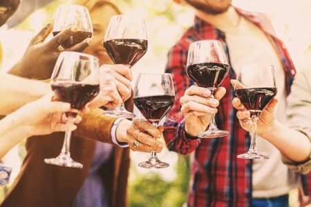 Photo for Best friends raising wine glasses toasting and celebrating friendship together - crop shot - closeup on the glasses - group of people cheering at farmhouse outdoors restaurant enjoying weekend - Royalty Free Image