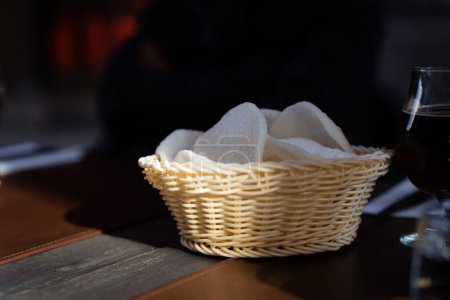 Photo for Rice traditional chips in a wicker basket stand on the table of a street restaurant, side view close-up selective focus. - Royalty Free Image