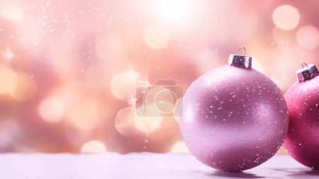 Photo for Two beautiful soft pink Christmas balls lie on the right in the snow with copy space on the left against a background of blurred bokeh, close-up side view. - Royalty Free Image