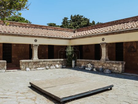 Beautiful view of the inner courtyard of the temple of the Virgin with architectural stones from the temple of Zeus on Mount Filerimos in Greece on the island of Rhodes, close-up side view. The