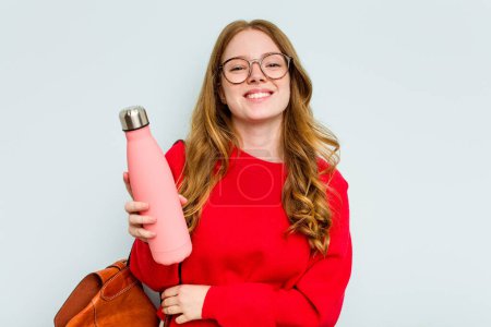 Photo for Young student woman holding a canteen isolated on blue background laughing and having fun. - Royalty Free Image