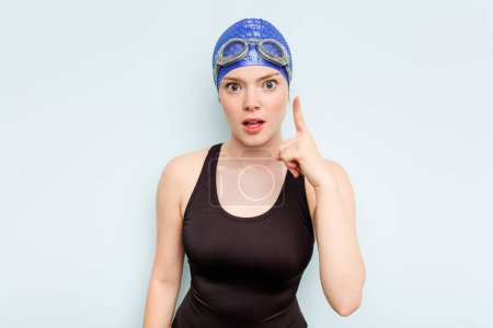 Photo for Young caucasian swimmer woman isolated on blue background having an idea, inspiration concept. - Royalty Free Image